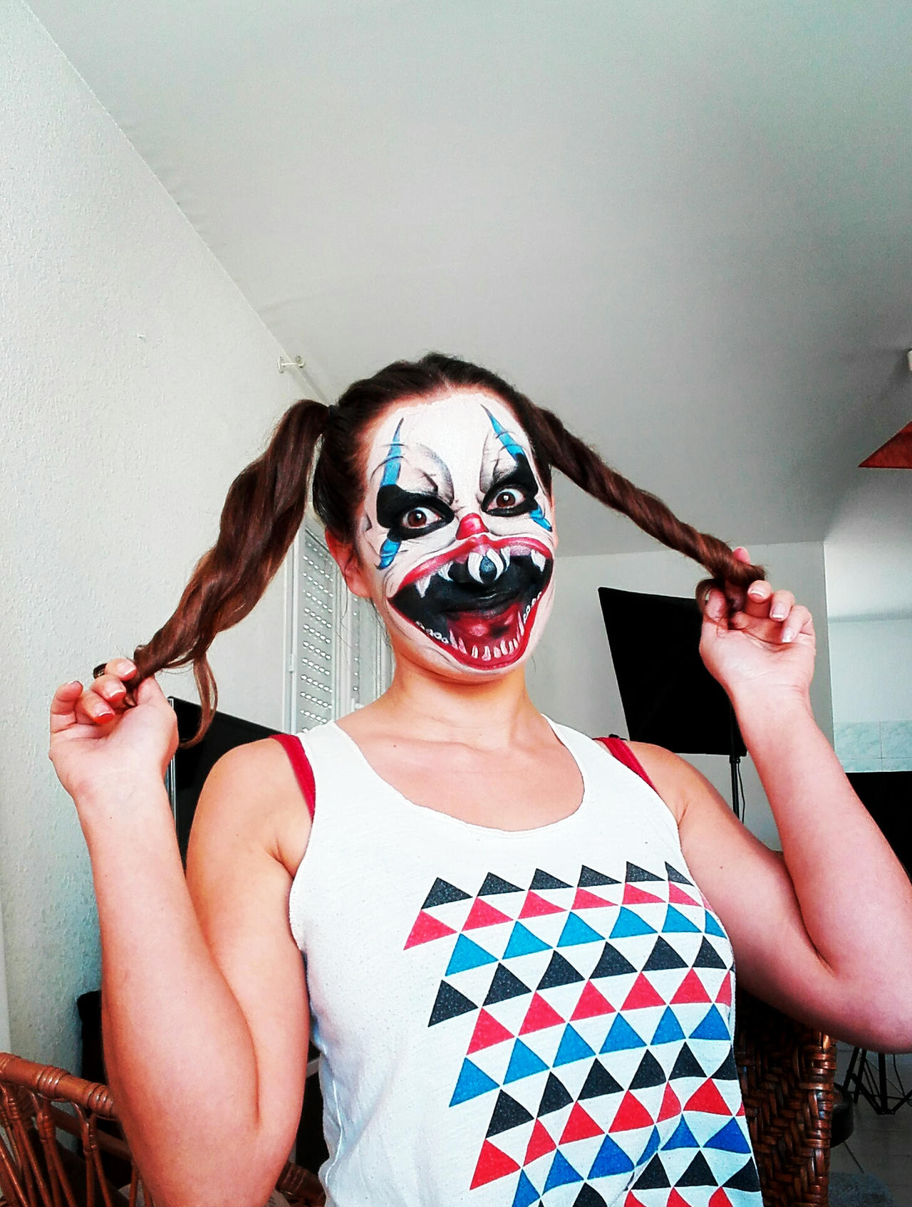 Creepy clown makeup with a white and red face stripe