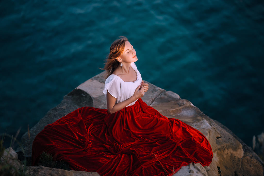 Beautiful Girl in red dress on sea background by Black ...